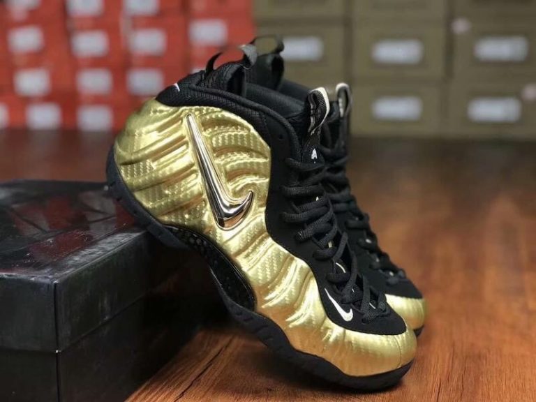 all black foams with gold nike sign